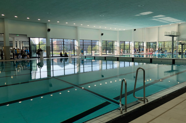 Schwimmhalle mit spiegelglatten Wasserbecken