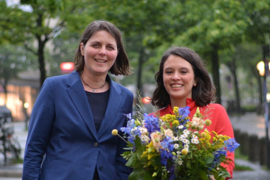 Delara Burkhardt mit Bumenstrauß und Gesine Stück stehen in der Straße