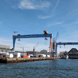 Blick vom Wasser auf die Portalkräne und Gebäude der Werft German Naval Yards