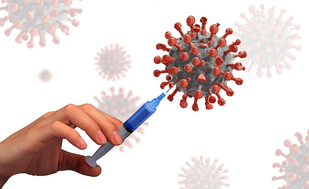 Nadel sticht in stilisiertes Coronavirus